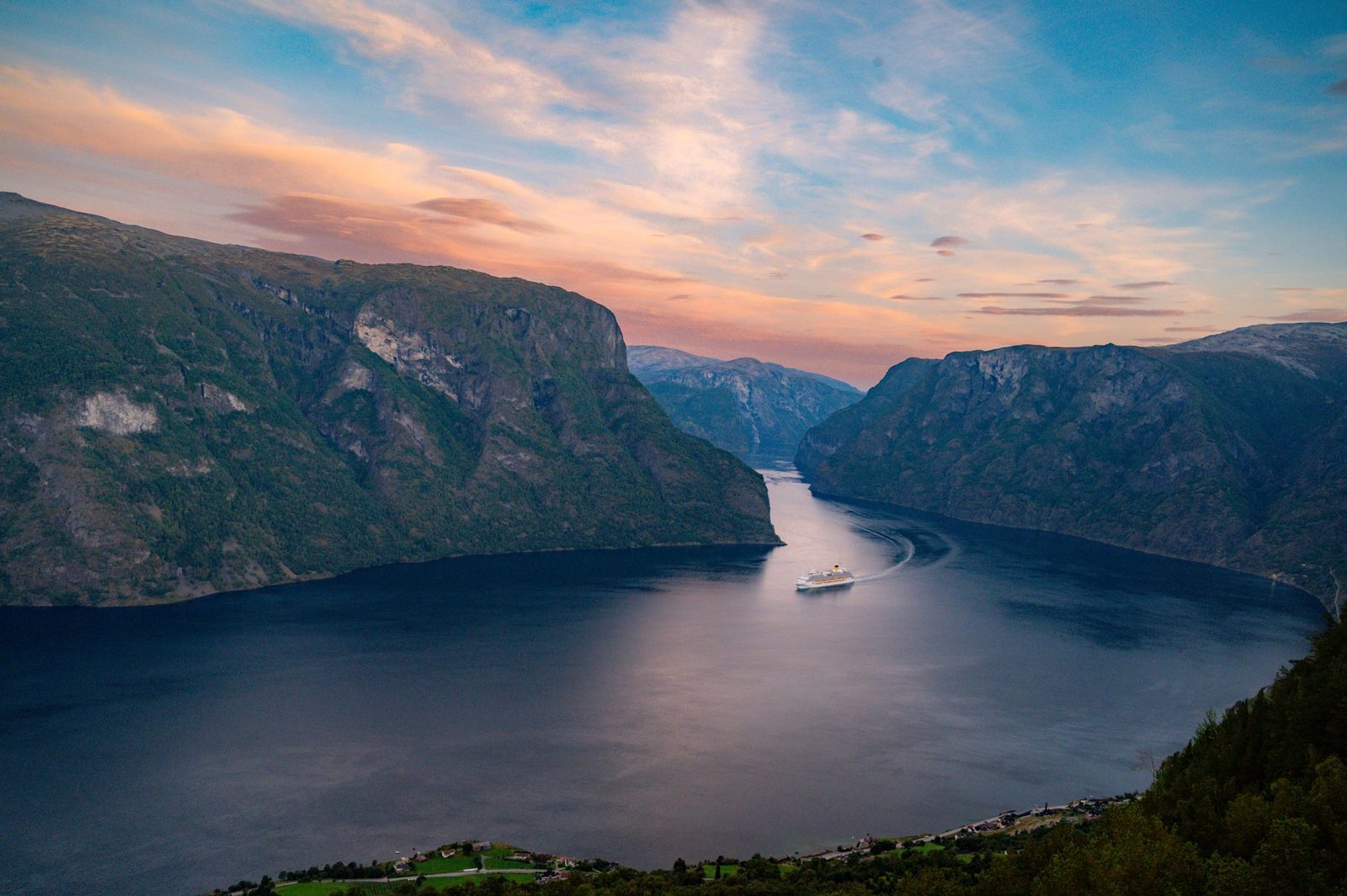Cruise ship in a Norwegian fjord at sunset